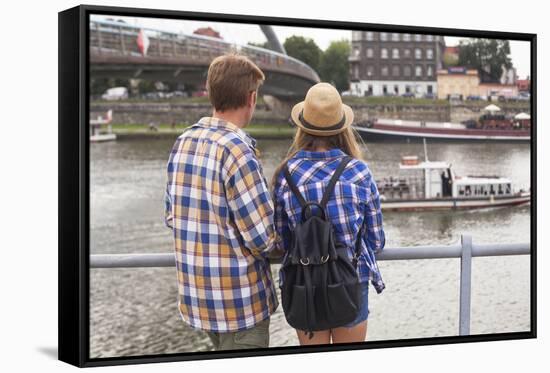 Young Couple on the River Bank in a European City (Rear View) Romantic Journey.-De Visu-Framed Stretched Canvas