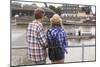 Young Couple on the River Bank in a European City (Rear View) Romantic Journey.-De Visu-Mounted Photographic Print