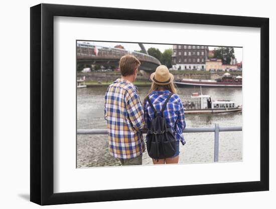 Young Couple on the River Bank in a European City (Rear View) Romantic Journey.-De Visu-Framed Photographic Print