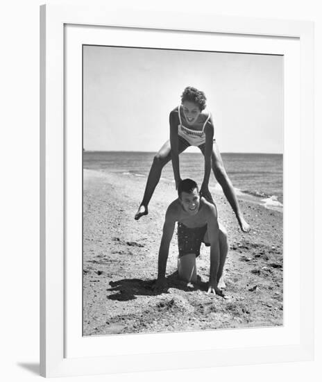 Young Couple Playing Leapfrog on the Beach-The Chelsea Collection-Framed Giclee Print