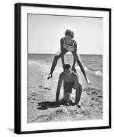 Young Couple Playing Leapfrog on the Beach-The Chelsea Collection-Framed Giclee Print