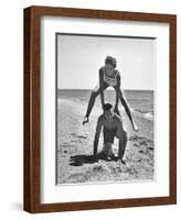 Young Couple Playing Leapfrog on the Beach-The Chelsea Collection-Framed Art Print