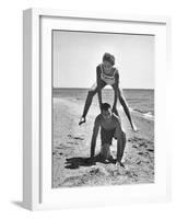 Young Couple Playing Leapfrog on the Beach-The Chelsea Collection-Framed Art Print