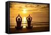 Young Couple Practicing Yoga On The Sea Beach At Sunset-De Visu-Framed Stretched Canvas