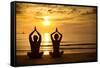 Young Couple Practicing Yoga On The Sea Beach At Sunset-De Visu-Framed Stretched Canvas