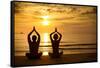 Young Couple Practicing Yoga On The Sea Beach At Sunset-De Visu-Framed Stretched Canvas