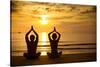 Young Couple Practicing Yoga On The Sea Beach At Sunset-De Visu-Stretched Canvas