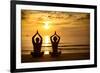 Young Couple Practicing Yoga On The Sea Beach At Sunset-De Visu-Framed Art Print