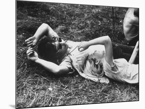 Young Couple Relaxing During Woodstock Music Festival-Bill Eppridge-Mounted Photographic Print