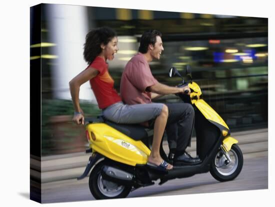 Young Couple Riding on a Motor Scooter-null-Stretched Canvas