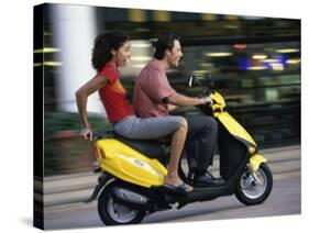 Young Couple Riding on a Motor Scooter-null-Stretched Canvas