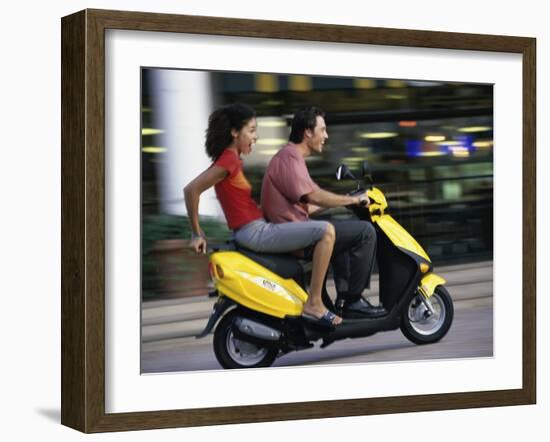 Young Couple Riding on a Motor Scooter-null-Framed Premium Photographic Print