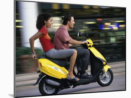 Young Couple Riding on a Motor Scooter-null-Mounted Premium Photographic Print