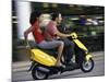 Young Couple Riding on a Motor Scooter-null-Mounted Photographic Print