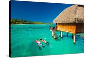 Young Couple Snorkeling from Hut over Blue Tropical Lagoon-Martin Valigursky-Stretched Canvas