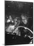Young Couple Snuggling in Convertible as They Intently Watch Movie at Drive-in Movie Theater-J^ R^ Eyerman-Mounted Photographic Print