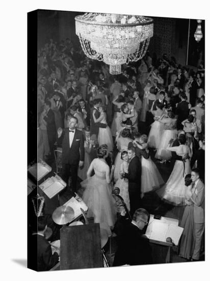 Young Couples at Formal Dance Dreamily Swaying on Crowded Floor of Dim, Chandelier-Lit Ballroom-Nina Leen-Stretched Canvas