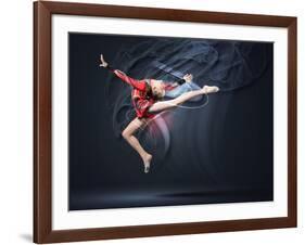 Young Cute Woman In Gymnast Suit Show Athletic Skill On Black Background-Sergey Nivens-Framed Art Print