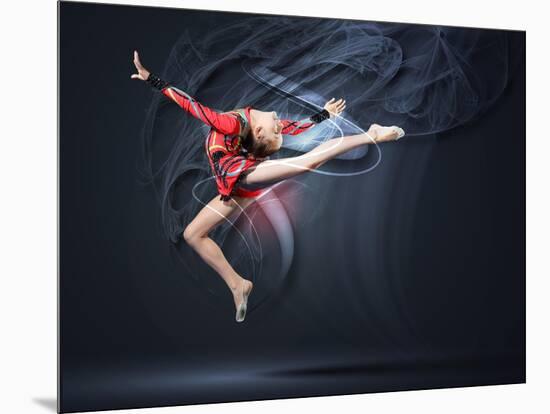 Young Cute Woman In Gymnast Suit Show Athletic Skill On Black Background-Sergey Nivens-Mounted Art Print