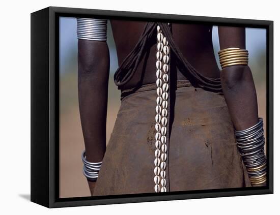 Young Dassanech Girl Wears a Leather Skirt, Metal Bracelets, Amulets and Bead Necklaces, Ethiopia-John Warburton-lee-Framed Stretched Canvas