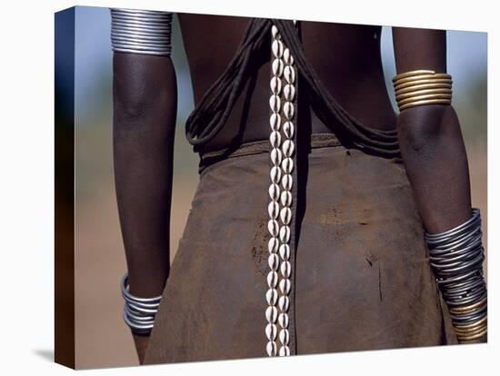 Young Dassanech Girl Wears a Leather Skirt, Metal Bracelets, Amulets and Bead Necklaces, Ethiopia-John Warburton-lee-Stretched Canvas