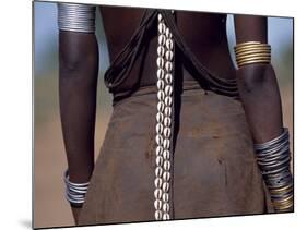 Young Dassanech Girl Wears a Leather Skirt, Metal Bracelets, Amulets and Bead Necklaces, Ethiopia-John Warburton-lee-Mounted Photographic Print