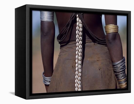 Young Dassanech Girl Wears a Leather Skirt, Metal Bracelets, Amulets and Bead Necklaces, Ethiopia-John Warburton-lee-Framed Stretched Canvas