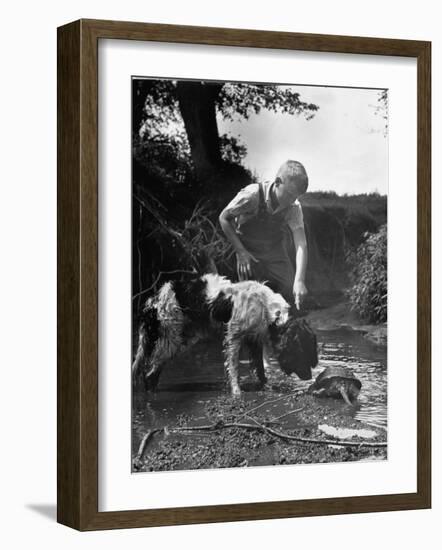 Young Farm Boy Watching His Dog Sniff a Large Turtle at the Pond-Myron Davis-Framed Photographic Print