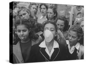 Young Girl Blowing a Bubble with Her Friends Watching-Bob Landry-Stretched Canvas