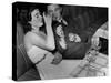 Young Girl Drinking the Remains of the Other Glasses on the Table after Finishing Her Own Champagne-null-Stretched Canvas