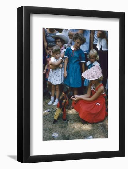 Young Girl in a Bonnet and a Red Dress Feeding an Organ Grinder's Monkey, Iowa State Fair, 1955-John Dominis-Framed Photographic Print