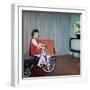 Young Girl Rides Her New Tricycle in the House, Ca. 1967-null-Framed Photographic Print