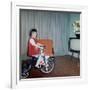 Young Girl Rides Her New Tricycle in the House, Ca. 1967-null-Framed Photographic Print