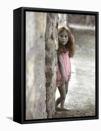 Young Girl Standing Against a Stone Wall-Nora Hernandez-Framed Stretched Canvas