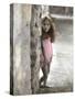 Young Girl Standing Against a Stone Wall-Nora Hernandez-Stretched Canvas