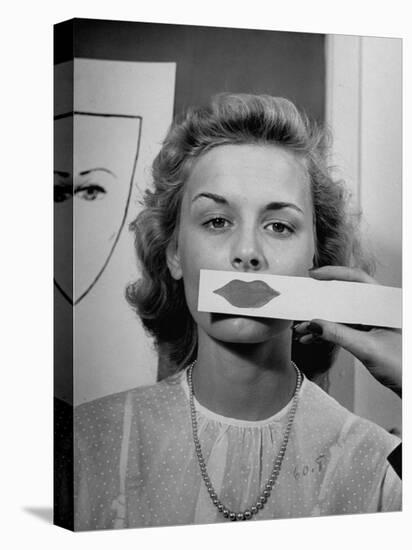 Young Girl Trying to Determine Which Lipstick Color Will Look Right with Her Complextion-Nina Leen-Stretched Canvas