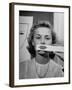 Young Girl Trying to Determine Which Lipstick Color Will Look Right with Her Complextion-Nina Leen-Framed Photographic Print