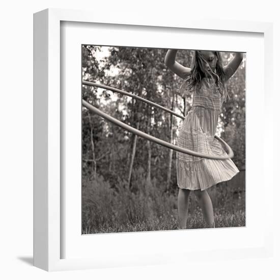 Young Girl Twirling Hula Hoop Outdoors In Sepia For Vintage Look-CherylCasey-Framed Art Print