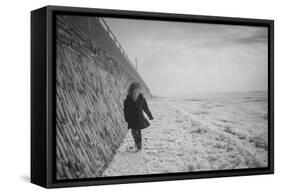 Young Girl Walking Beside the Sea Wall in England During Winter-Clive Nolan-Framed Stretched Canvas