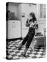 Young Girl Wearing Cowgirl Outfit Drinking Milk and Eating Sandwich in Kitchen-Nina Leen-Stretched Canvas