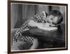 Young Girl Writes on Paper with a Pencil-null-Framed Art Print