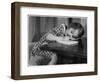 Young Girl Writes on Paper with a Pencil-null-Framed Art Print