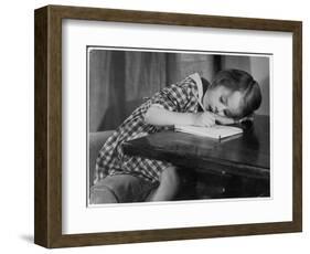 Young Girl Writes on Paper with a Pencil-null-Framed Art Print