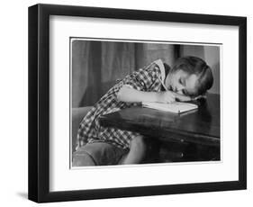 Young Girl Writes on Paper with a Pencil-null-Framed Art Print