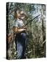 Young Hunter Blowing a Duck Decal Wistle while Holding His Rifle under His Arm-Al Fenn-Stretched Canvas