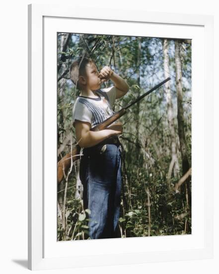 Young Hunter Blowing a Duck Decal Wistle while Holding His Rifle under His Arm-Al Fenn-Framed Photographic Print