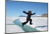 Young Inuit Boy Jumping over a Crack on Ice Floe, Ellesmere Island, Nanavut, Canada, June 2012-Eric Baccega-Mounted Photographic Print