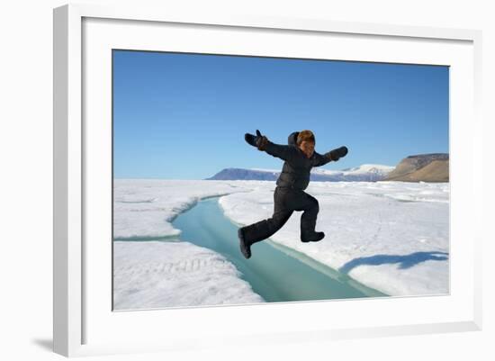 Young Inuit Boy Jumping over a Crack on Ice Floe, Ellesmere Island, Nanavut, Canada, June 2012-Eric Baccega-Framed Photographic Print