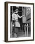 Young Lady Modeling New Line of Clothing While Getting Her Time Card Punched-Yale Joel-Framed Photographic Print