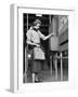 Young Lady Modeling New Line of Clothing While Getting Her Time Card Punched-Yale Joel-Framed Photographic Print